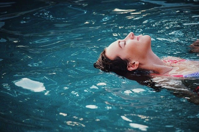 žena koupající se v bazénu